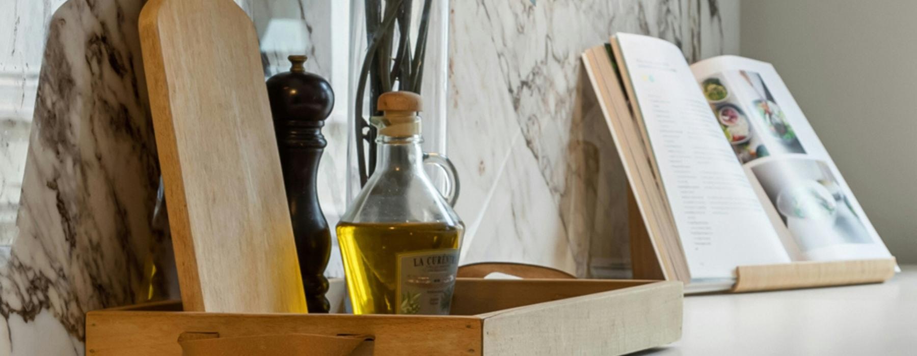 Oil, cutting boards and kitchen supplies on a counter at The Bellwether Denver apartments for rent.